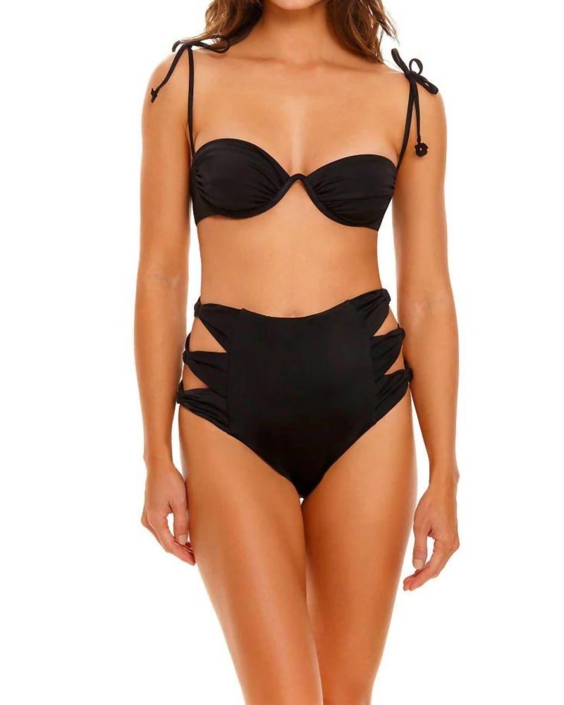 Front of a model wearing a size LARGE Aliz Cut Out Bikini Bottom In Black in Black by AGUA BENDITA. | dia_product_style_image_id:360808